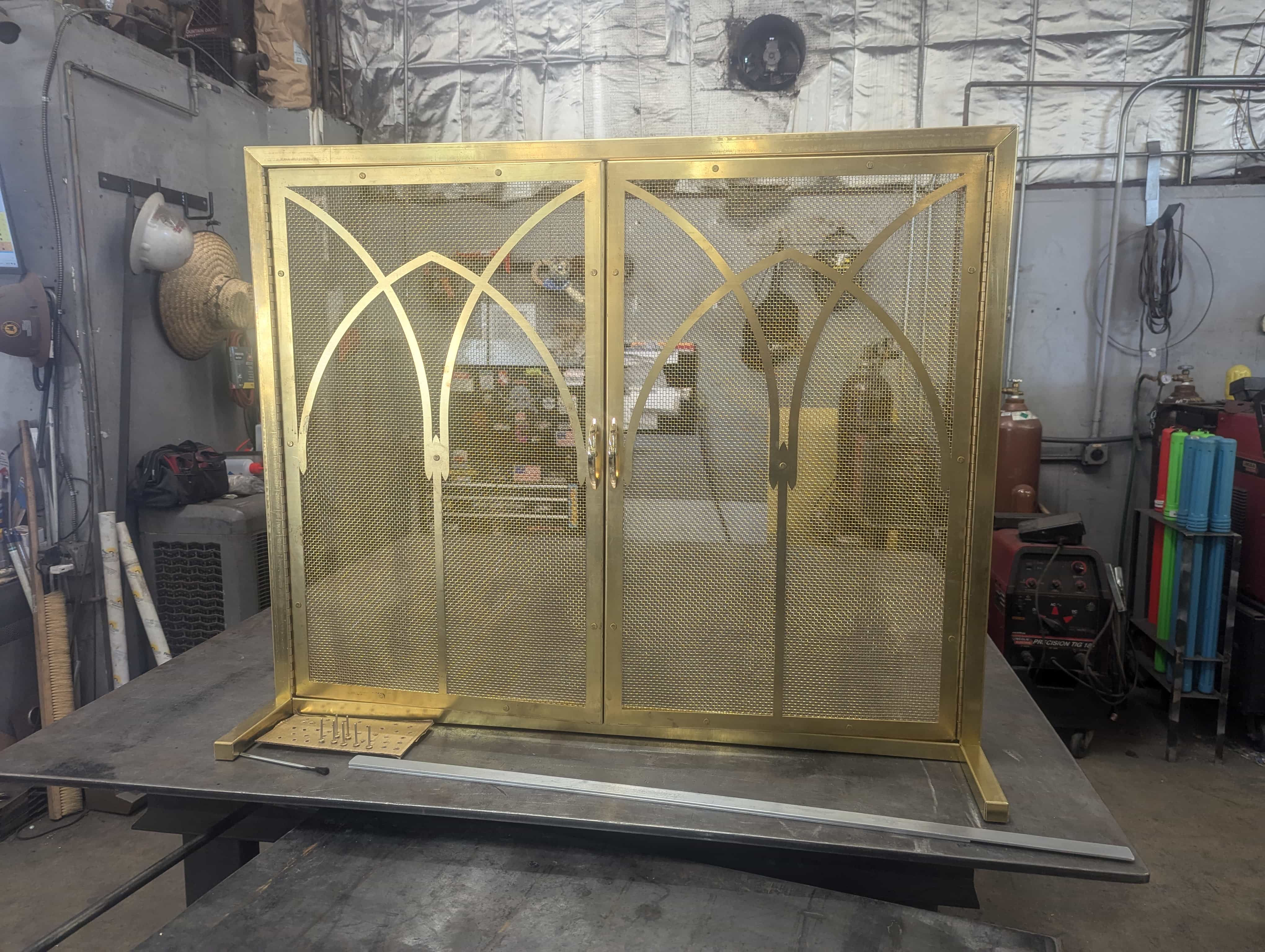 Custom gold mesh doors on a shop table