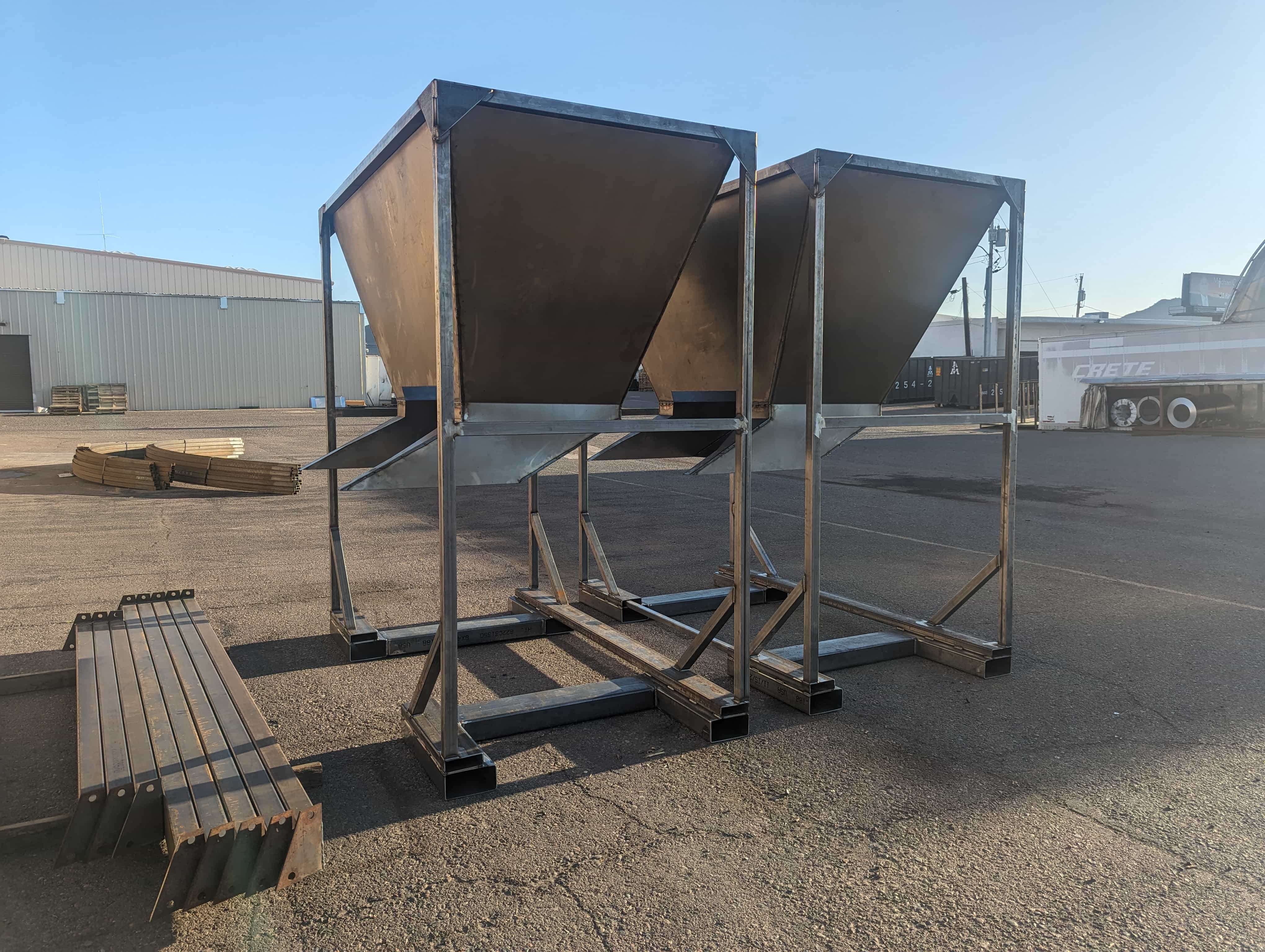 Large custom hopper assemblies fabricated from structural and sheet metal